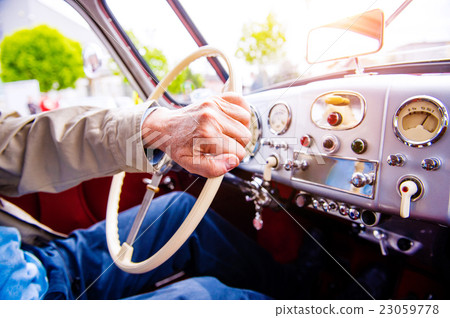 Stock Photo: Close up unrecognizable man driving a veteran car