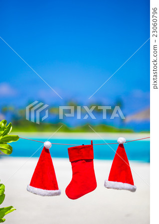 Red Santa hats and Christmas stocking hanging on Red Santa hats and Christmas stocking hanging on 23060796