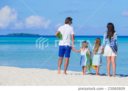 Young family on white beach during summer vacation Young family on white beach during summer vacation 23060809