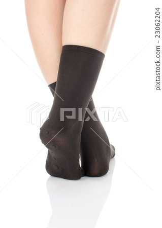 Female crossed legs, feet, brown socks 23062204