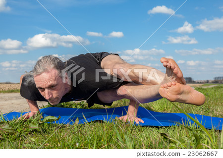 Enjoy astavakrasana yoga in Nature 23062667