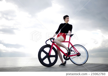 Woman posing with bike Woman posing with bike 23062760