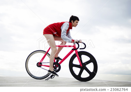 Female with rental bike enjoying weekend stroll Female with rental bike enjoying weekend stroll 23062764