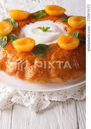 French Savarin cake decorated with apricots 23063425