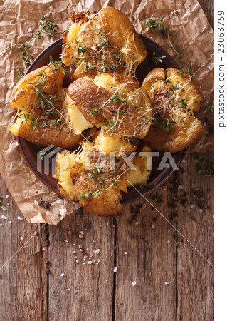 crash hot potatoes with thyme on a plate close-up 23063759