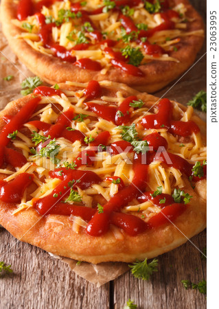 Hot langos fried with cheese and ketchup macro Hot langos fried with cheese and ketchup macro 23063995