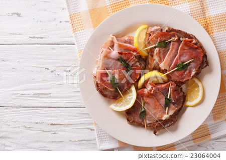 Beef Saltimbocca with sage and ham close-up 23064004