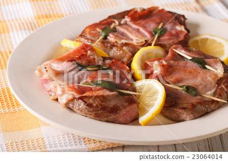 Beef Saltimbocca with sage and ham close-up Beef Saltimbocca with sage and ham close-up 23064014