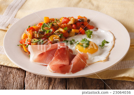 Spanish cuisine fried egg, jamon and vegetable 23064036