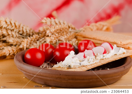 Brown clay plate with crispy bread and curd cheese Brown clay plate with crispy bread and curd cheese 23064453