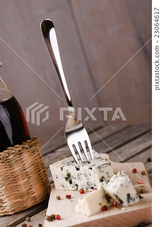 Shiny fork placed in blue cheese Shiny fork placed in blue cheese 23064617