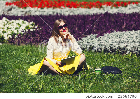 Young woman with tablet pc in the park Young woman with tablet pc in the park 23064796