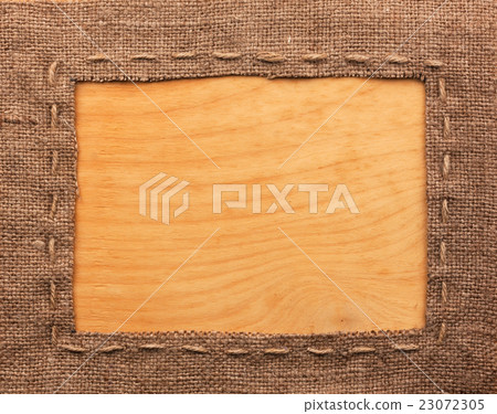 Frame of burlap, lies on a background of wood Frame of burlap, lies on a background of wood 23072305