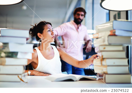 Asian female at exam preparation with classmate Asian female at exam preparation with classmate 23074522