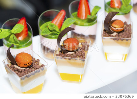 mini canapes in plastic cups decorated with edible 23076369