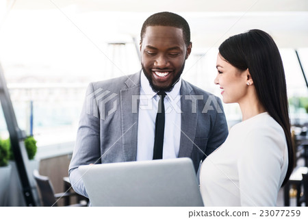 Cheerful colleagues talking 23077259