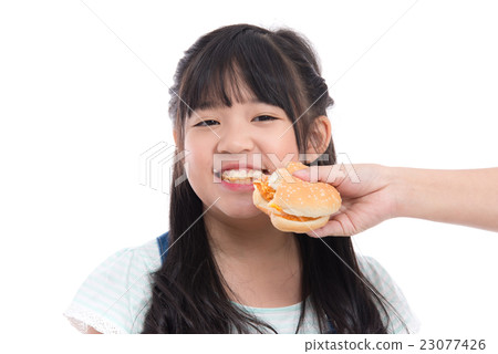 Beautiful asian girl eating hamburger Beautiful asian girl eating hamburger 23077426