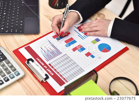 businesswoman checks start up report businesswoman checks start up report 23077675