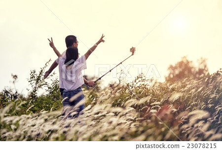 Couple of best friends taking selfie during sunset Couple of best friends taking selfie during sunset 23078215