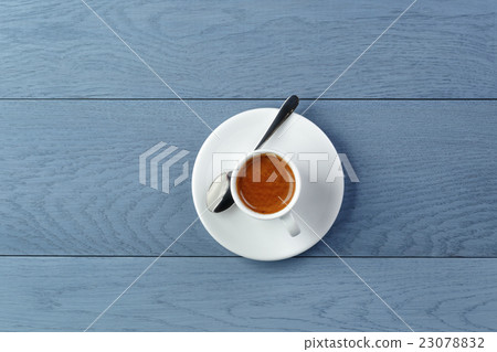 cup of fresh espresso on vintage blue table from above cup of fresh espresso on vintage blue table from above 23078832