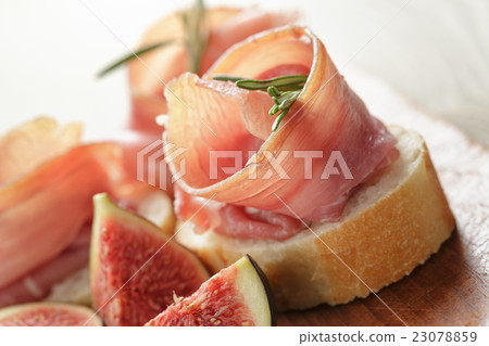 canapes with jamon and figs on wooden board canapes with jamon and figs on wooden board 23078859