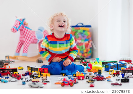 Little boy playing with toy cars 23079878