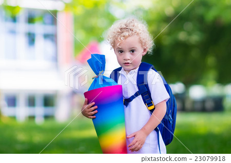 Little child with candy cone on first school day Little child with candy cone on first school day 23079918