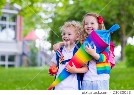 Kids with candy cone on first school day. Kids with candy cone on first school day. 23080038