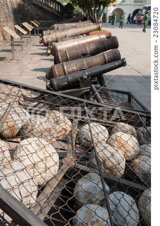 Stone ammunition of the thrower exhibited at the military history museum in Vietnam and cannon used in the 18th and 19th centuries 23084720