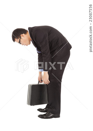 tired young businessman rubbing his eyes  23087556