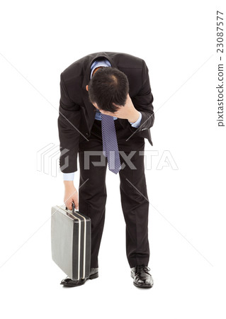 afflictive businessman stoop and hold his head 23087577