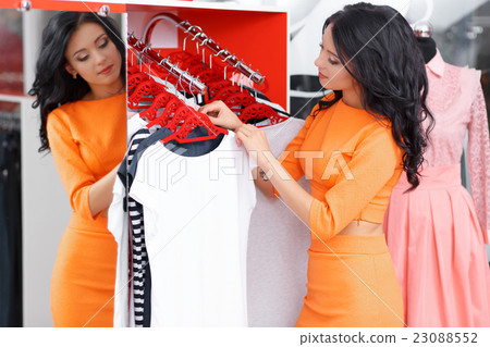 Beautiful young woman shopping in a clothing store 23088552