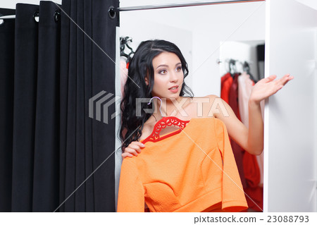 The young woman is dressed in a fitting shop The young woman is dressed in a fitting shop 23088793