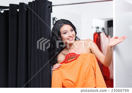 The young woman is dressed in a fitting shop The young woman is dressed in a fitting shop 23088799