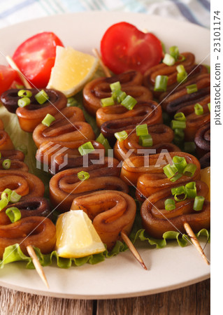 Grilled squid on skewers with vegetables close-up 23101174
