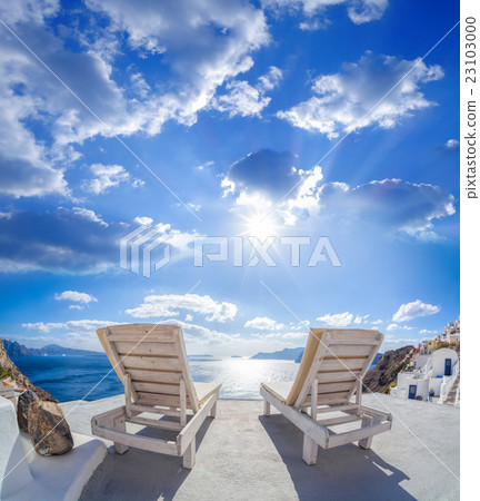 Oia village with sunbeds on Santorini in Greece 23103000