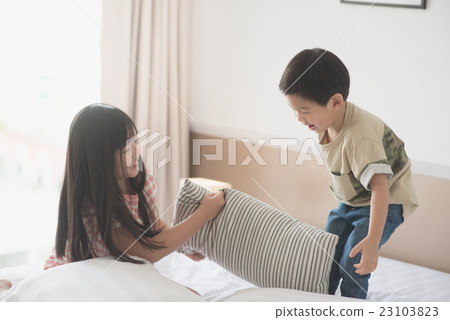 Asian child having Pillow Fight in Hotel Room 23103823