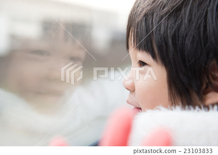 Happy asian child looking out train window outside Happy asian child looking out train window outside 23103833