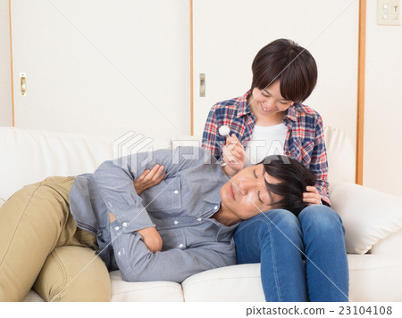 Couples doing ear cleaning with knee pillow Couples doing ear cleaning with knee pillow 23104108
