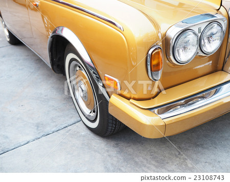 Front of yellow classic car 23108743