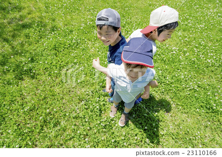 Elementary school students playing in a fresh green park 23110166