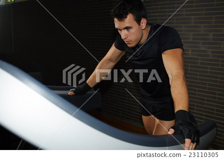 Attractive young man training indoors 23110305