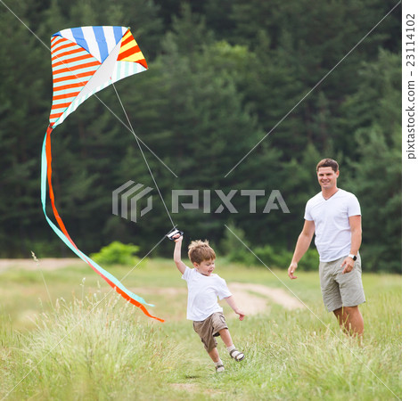 Father playing with son in park Father playing with son in park 23114102
