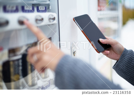 Woman use of soft drink vending system paying by cellphone 23116358