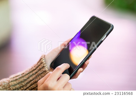 Woman touch on the screen of mobile phone 23116568
