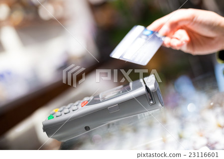 Woman paying with NFC technology on credit card, Woman paying with NFC technology on credit card, 23116601