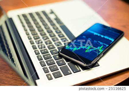 Laptop computer and Smartphone with stock market graph Laptop computer and Smartphone with stock market graph 23116625