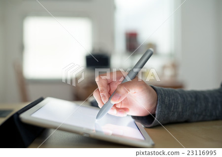 Woman using pen drafting on tablet Woman using pen drafting on tablet 23116995