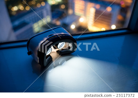 Virtual reality headset with cityscape background Virtual reality headset with cityscape background 23117372