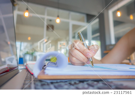 Business woman hand typing on laptop keyboard with Financial charts on the table . Business woman hand typing on laptop keyboard with Financial charts on the table . 23117561